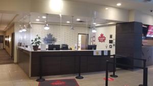 a restaurant with a counter in the middle of a room at Canad Inns Health Sciences Centre in Winnipeg