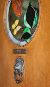 a door with a door knocker on it with a window at Starlight Lodge in Glenwood Springs