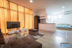 a living room with a couch and a tv at Apartments EON Gevgelija in Gevgelija