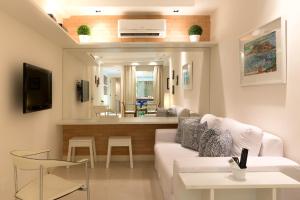 a living room with a white couch and a table at MC FLATS IPANEMA BEACH STAR in Rio de Janeiro