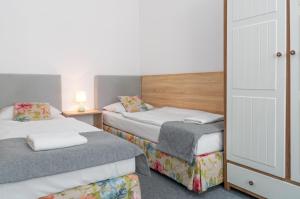Posteľ alebo postele v izbe v ubytovaní Nasze Kamienice Apartament Express Rzeszów Główny