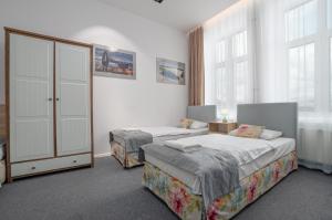 Posteľ alebo postele v izbe v ubytovaní Nasze Kamienice Apartament Express Rzeszów Główny