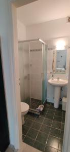 a bathroom with a shower and a toilet and a sink at Anemomylos Houses in Koufonisia +63 photos