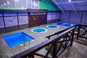 an overhead view of a gym with three blue pools at СПА Готель СВ in Khmelnytskyi