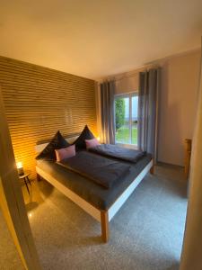 a bed in a room with a large window at Apartment 1 Zimmer in Friesenheim