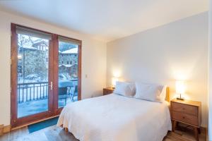 a bedroom with a bed and a balcony at Ballard South in Telluride