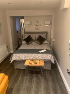 a bedroom with a large bed with a wooden table at The Ashfield in Sutton in Ashfield