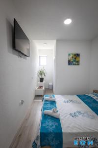 a bedroom with a bed with two people laying on it at Apartments EON Gevgelija in Gevgelija