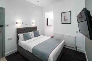 Postel nebo postele na pokoji v ubytování Apollo Hotel Kings Cross