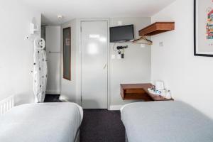 Postel nebo postele na pokoji v ubytování Apollo Hotel Kings Cross