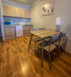 a kitchen with a table and chairs in a room at Apartamenty Olsztyn in Olsztyn +63 photos
