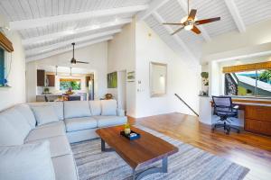 a living room with a white couch and a table at Hale Lani Lei in Princeville