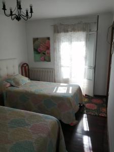 Posteľ alebo postele v izbe v ubytovaní Pensión Casa Frade