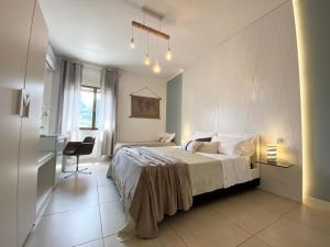 um quarto com uma cama, uma secretária e uma cadeira em BARI ROOMS Suite Station em Bari