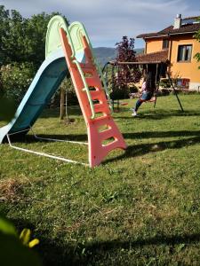a playground with a slide in a yard at Appartamento/ mansarda nel cuore del Pollino in Viggianello
