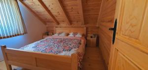 a bedroom in a log cabin with a bed in it at Vacation Home Andjelic in Žabljak