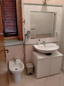 a bathroom with a sink and a toilet at La Bomboniera Cascia in Cascia