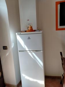 a white refrigerator with a bowl on top of it at La Bomboniera Cascia in Cascia