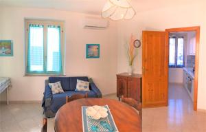 a living room with a couch and a table at Casa Verde in Cala Gonone