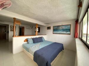 Postel nebo postele na pokoji v ubytování Hotel San Felipe de Jesus Yucatan