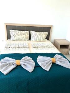 a bed with two bow ties on it at BEACH APARTMENT no 17 in St. St. Constantine and Helena