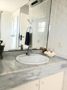a bathroom counter with a sink and a mirror at Beach Apartment Minerva in Port d'Alcudia +25 photos