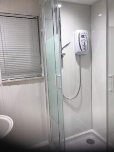 a bathroom with a shower with a glass door at No 10 The Cottage in Inverness