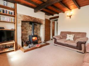 a living room with a couch and a fireplace at Sandywood in Skipton