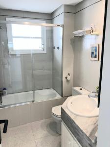 a bathroom with a shower and a toilet and a sink at Beach Apartment Minerva in Port d'Alcudia