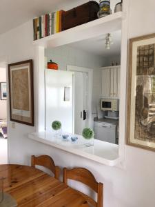 a kitchen with a table and a white refrigerator at Beach Apartment Minerva in Port d'Alcudia