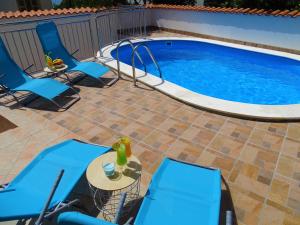 a patio with chairs and a swimming pool at Crikvenica Apartment 2 in Dramalj