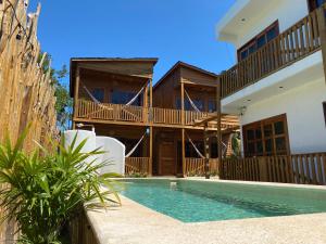 una casa con piscina frente a ella en Hotel Aruma Ha en Holbox Island