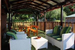 a patio with chairs and a table and a pergola at JOVIN SPLAV in Novi Sad