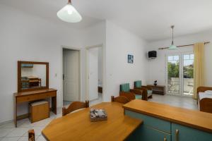 a living room with a wooden table and chairs at Tina's Apartments in Adamantas