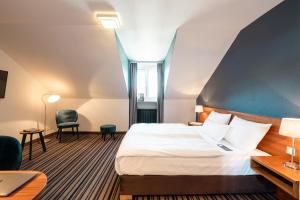 Postel nebo postele na pokoji v ubytování Hotel Stachus