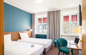 En eller flere senger på et rom på Hotel Stachus