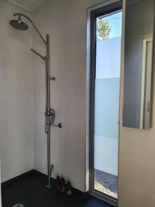 a shower with a glass door in a bathroom at The Cube in Martinborough 