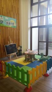 a classroom with a table and a blackboard in a room at Holiday Inn Express Haikou West Coast, an IHG Hotel in Haikou