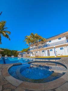 a swimming pool in front of a building at Hotel Arrastão in São Sebastião