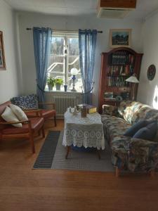 a living room with a couch and a table at Pilane B&B in Långekärr