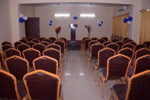 an empty room with chairs and blue balloons at Hotel JMD International Purnea in Pūrnia