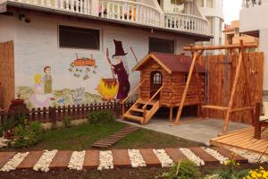 a mural on the side of a building with a playground at hotel Yanis in Lozenets