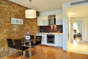 a kitchen and dining room with a table and chairs at Sani Polyastron Hotel & Spa in Sani Beach