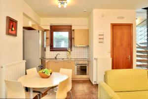 a small kitchen and dining room with a table and chairs at Sani Polyastron Hotel & Spa in Sani Beach