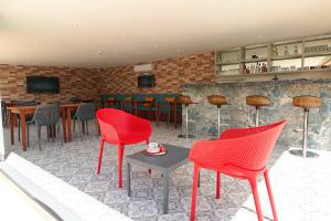 a restaurant with red chairs and a bar at Dna Hotel Dalyan in Dalyan