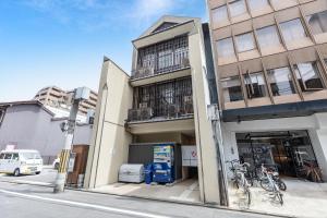 a building with bikes parked outside of it on a street at The Hotel Saint-Felicien Kyoto Shijo Karasuma in Kyoto