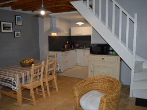 a kitchen with a table and chairs and a staircase at Gîte Saint-Nicolas-des-Motets, 3 pièces, 4 personnes - FR-1-381-145 in Saint-Nicolas-des-Motets