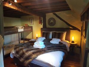 a bedroom with a large bed with towels on it at Maison Zanella in Durbuy