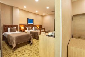 Postel nebo postele na pokoji v ubytování West Shine Hotel