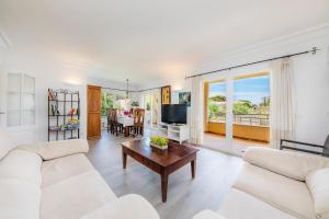 a living room with a couch and a table at Casa Luz in Cala Ratjada